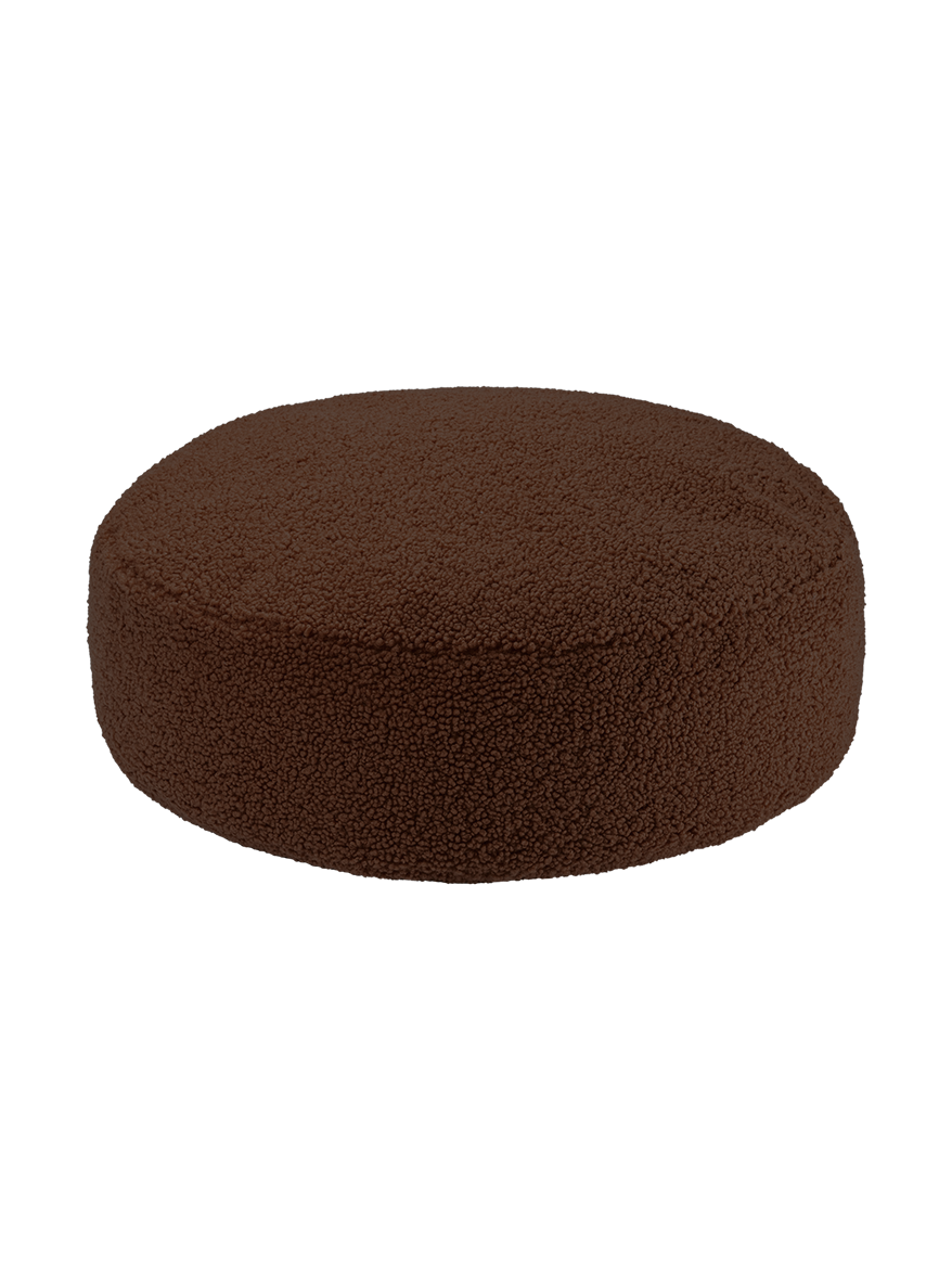 Dark brown round ottoman at angle on white background