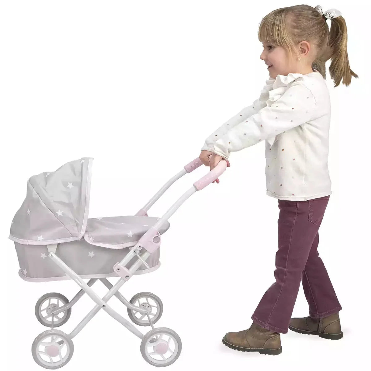 Young girl pushing the Arias Emma dolls pram in grey and pink