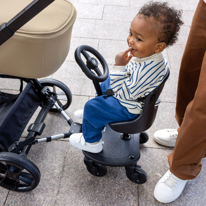 Be Cool 4ride bundle in use with pushchair, showing toddler riding position with steering wheel