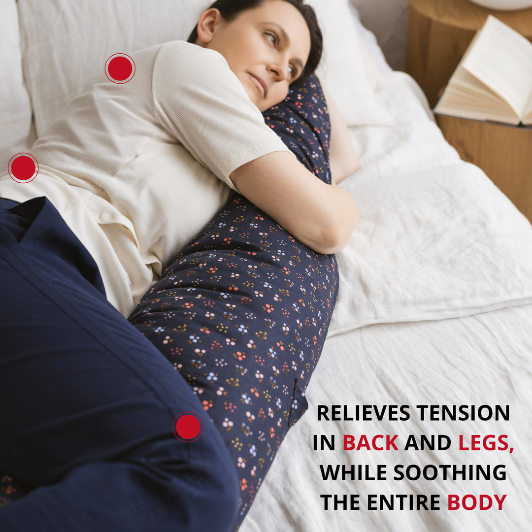 Woman side-sleeping supported by the MINICAMP Navy Blue floral C-Shape Pillow