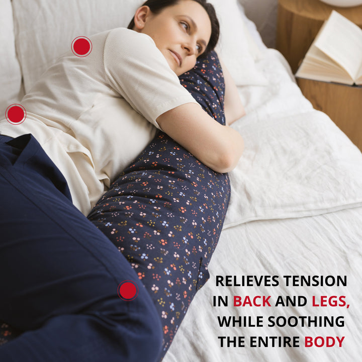 Woman side-sleeping supported by the MINICAMP Navy Blue floral C-Shape Pillow
