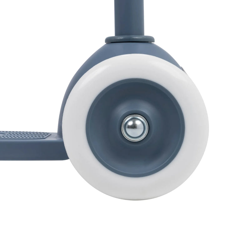 Close-up of rear wheel assembly with white tyre, blue hub and metal ball bearing