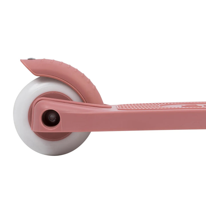 Close-up of rear brake pedal and white-rimmed pink wheel mechanism