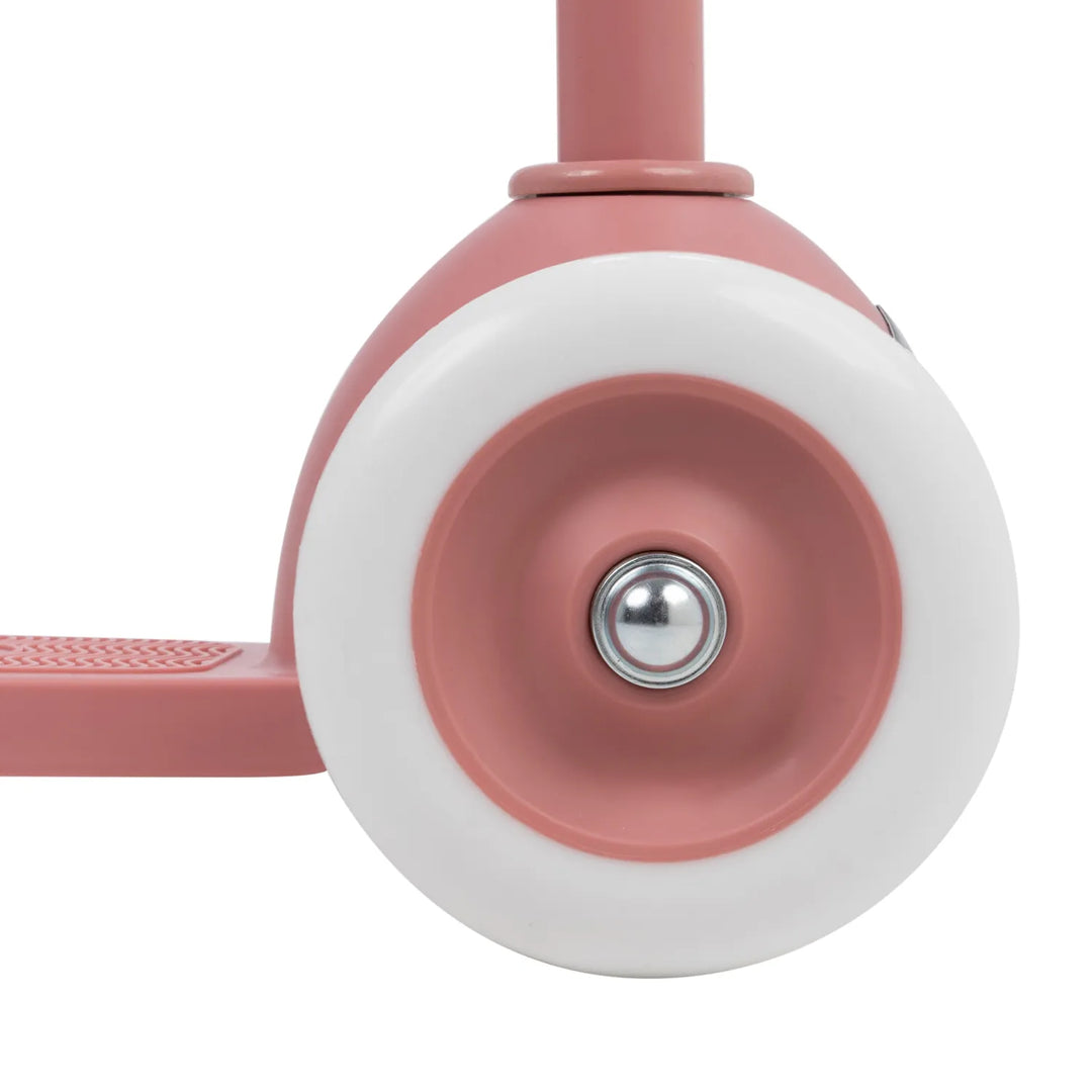 Front wheel close-up showing pink and white two-tone design with bearing detail