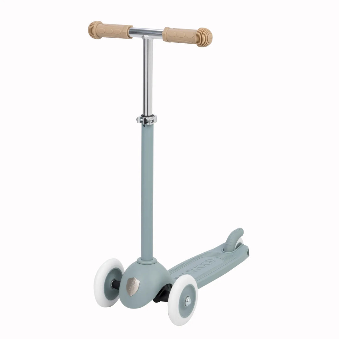 Three-quarter view of scooter with white wheels, brake mechanism and wooden grips Banwood