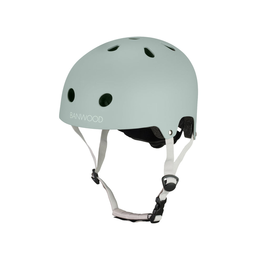 Sage green Banwood helmet angled view with visible ventilation and white straps