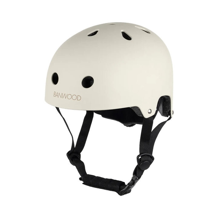 Cream Banwood helmet three-quarter view with black chin straps and ventilation ports