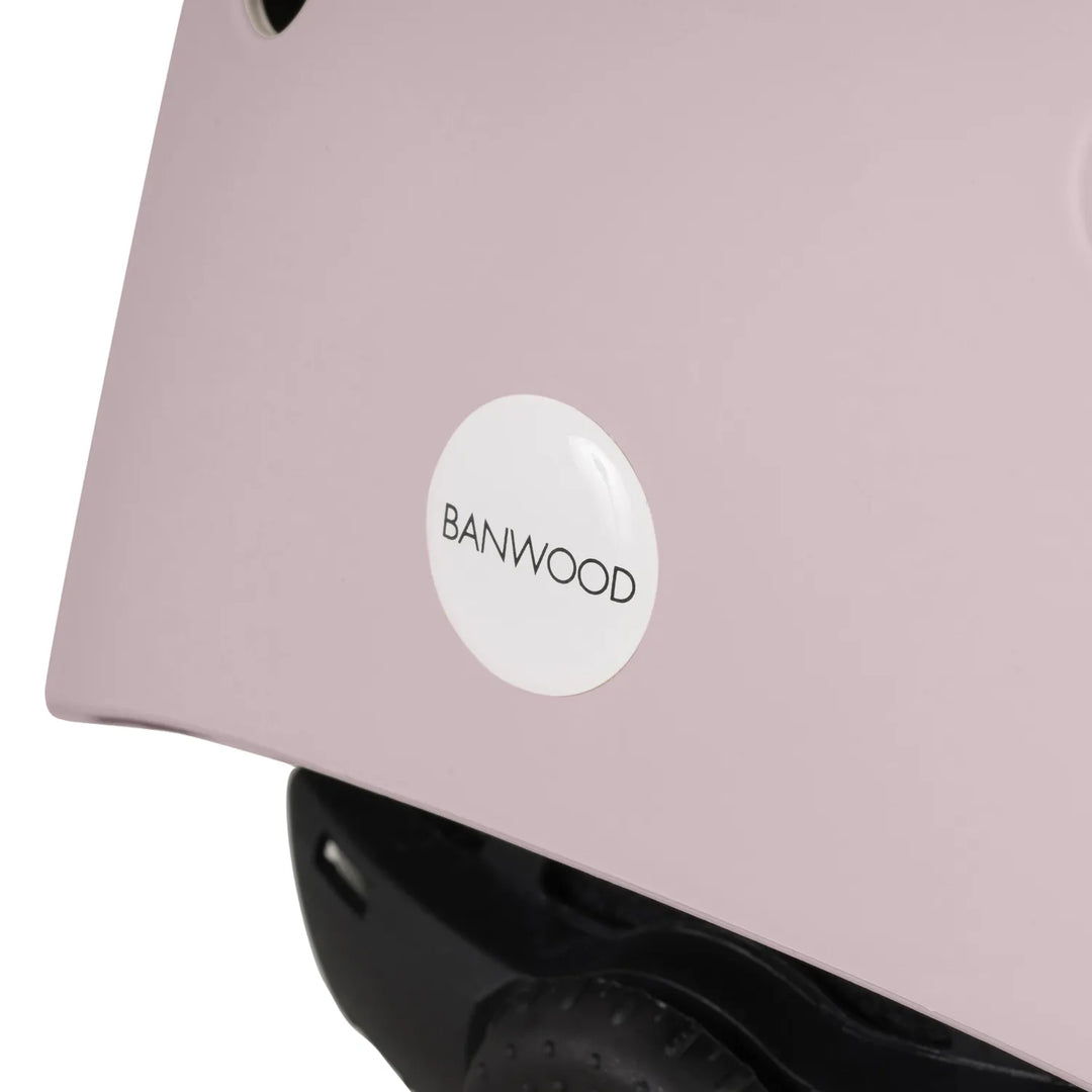 Close-up of pink Banwood helmet back showing white logo sticker and rear vent