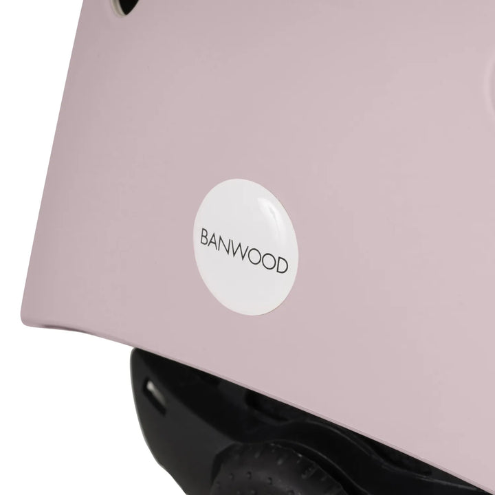 Close-up of pink Banwood helmet back showing white logo sticker and rear vent