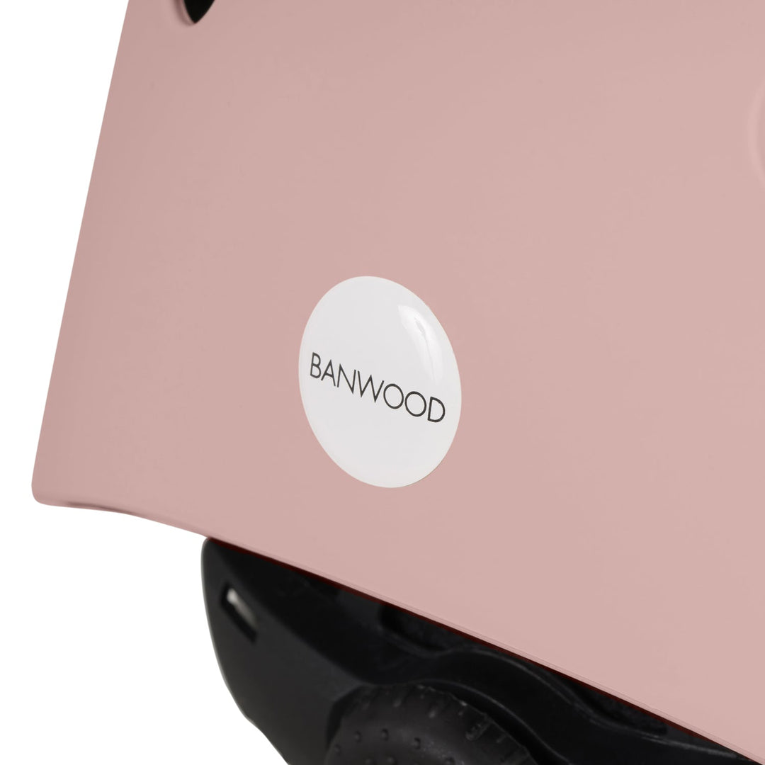 Back panel of dusty rose Banwood helmet showing white logo badge and black padding detail