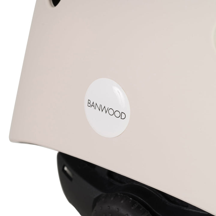 Close-up of Banwood logo detail on cream helmet side with black inner padding visible
