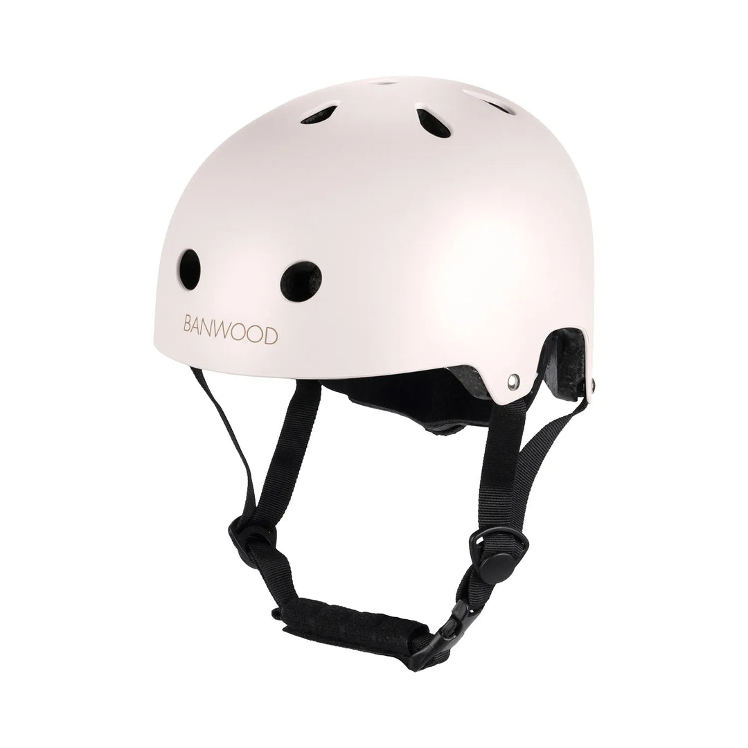 Pale pink helmet with black chin straps and ventilation holes, side profile view Banwood