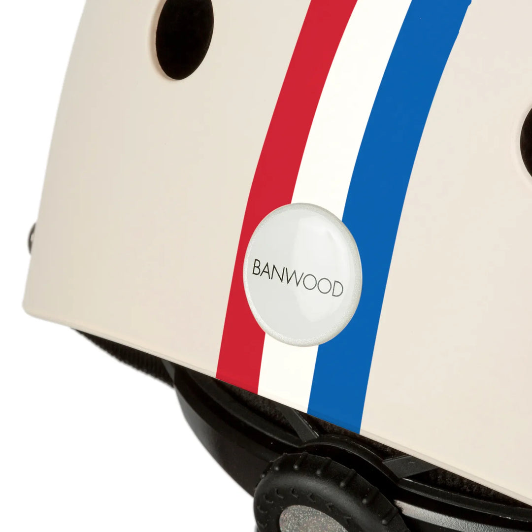 Banwood helmet rear detail, cream with blue and red stripes and logo badge