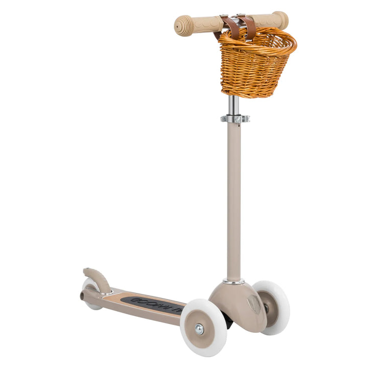 Beige scooter with woven wicker basket mounted on handlebars, side view