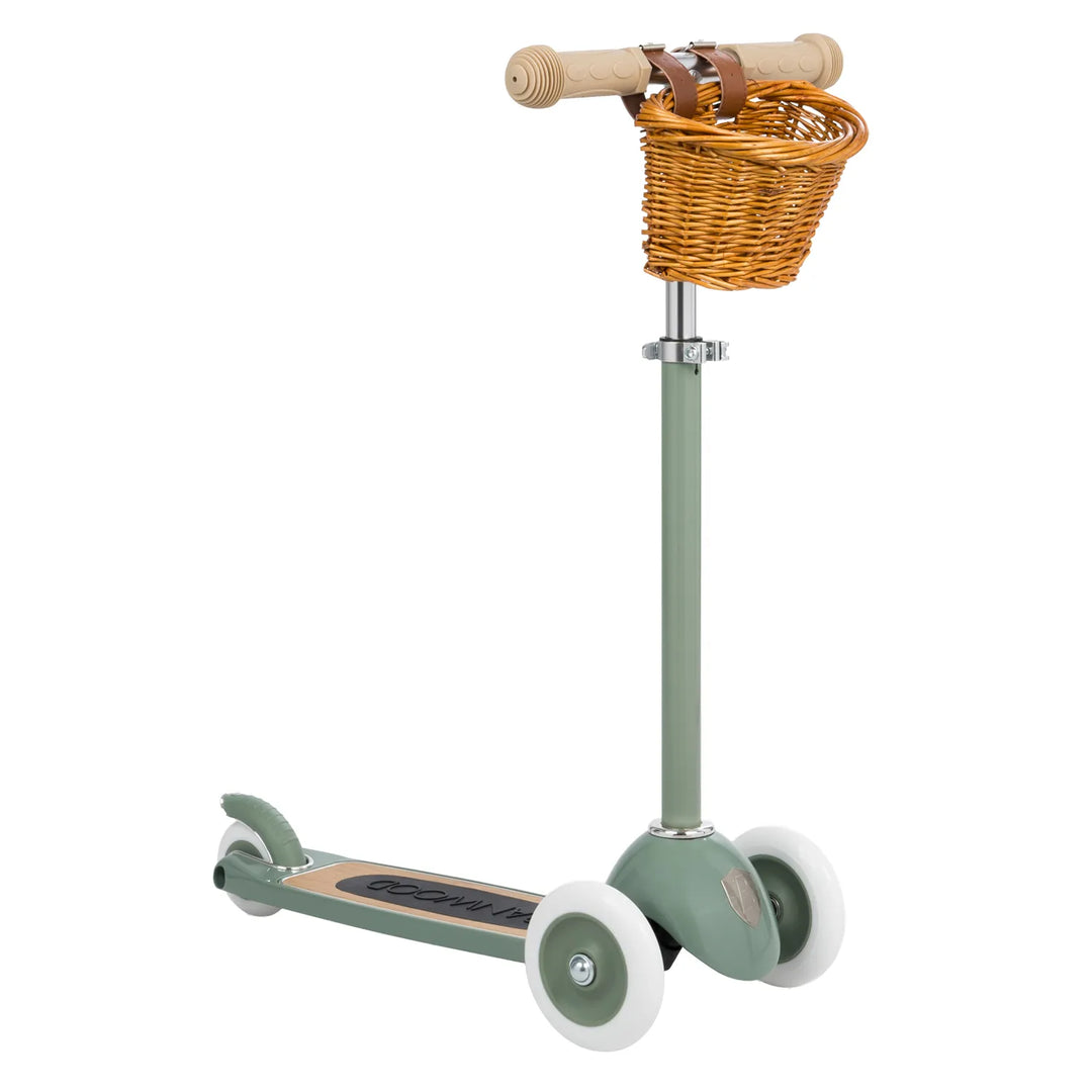 Green scooter with wicker basket and wooden handles, three-quarter view Banwood