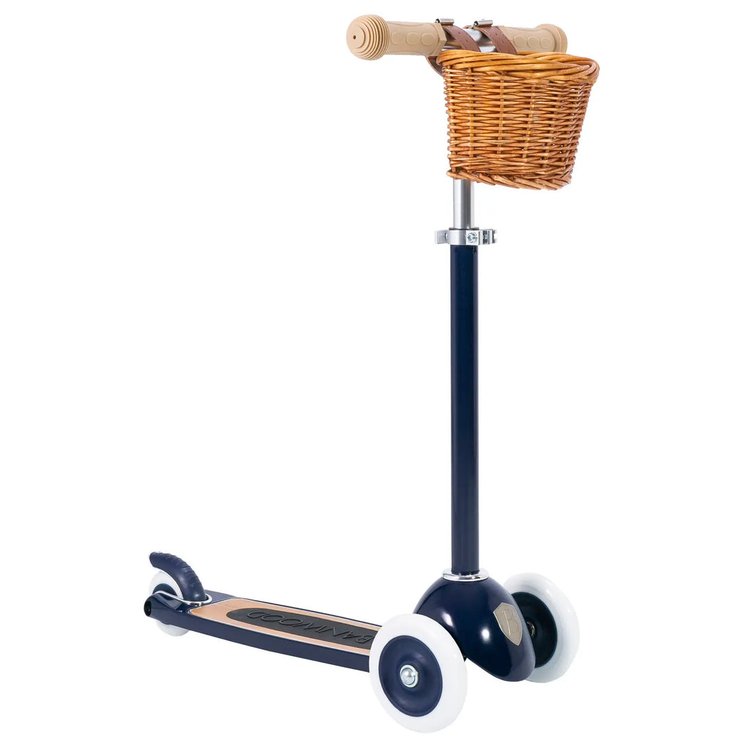 Navy scooter with wicker basket attached to handlebars Banwood