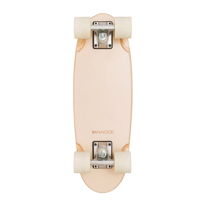 Assembled Banwood skateboard overhead view showing cream wheels and metal trucks