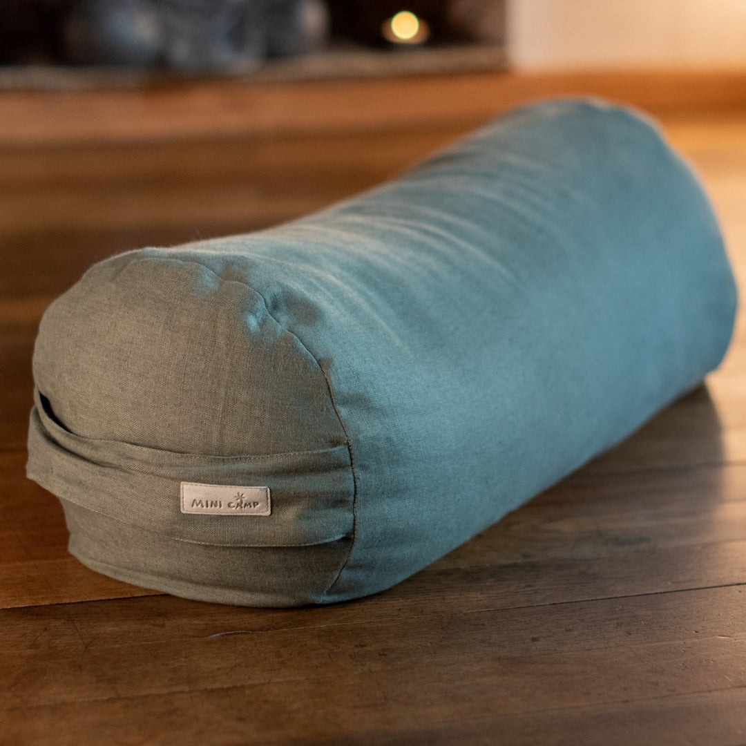 MINICAMP Forest Green linen yoga bolster, close view of the round end and woven MINICAMP label