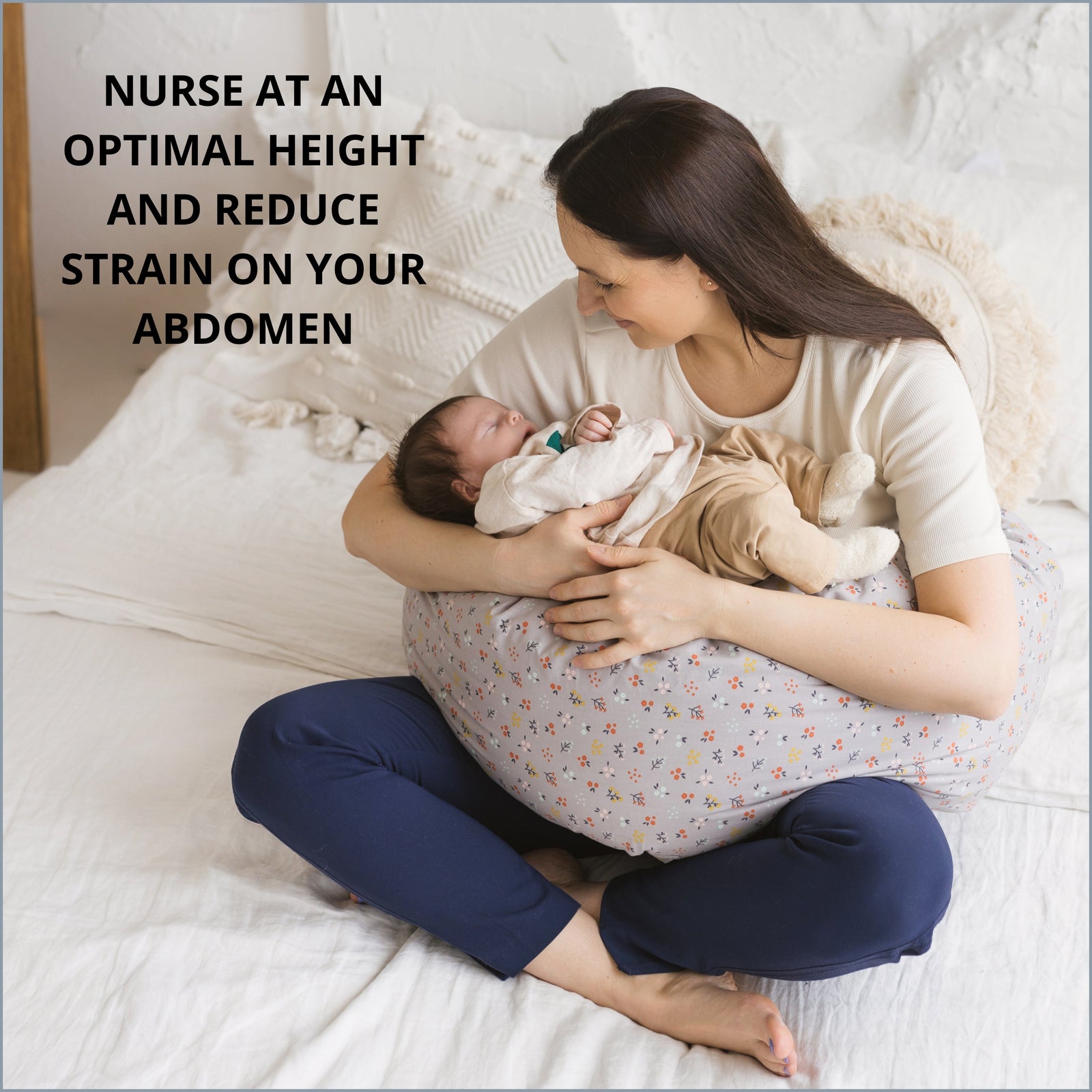 Woman nursing her baby at a comfortable height using the MINICAMP Grey floral C-Shape Pillow