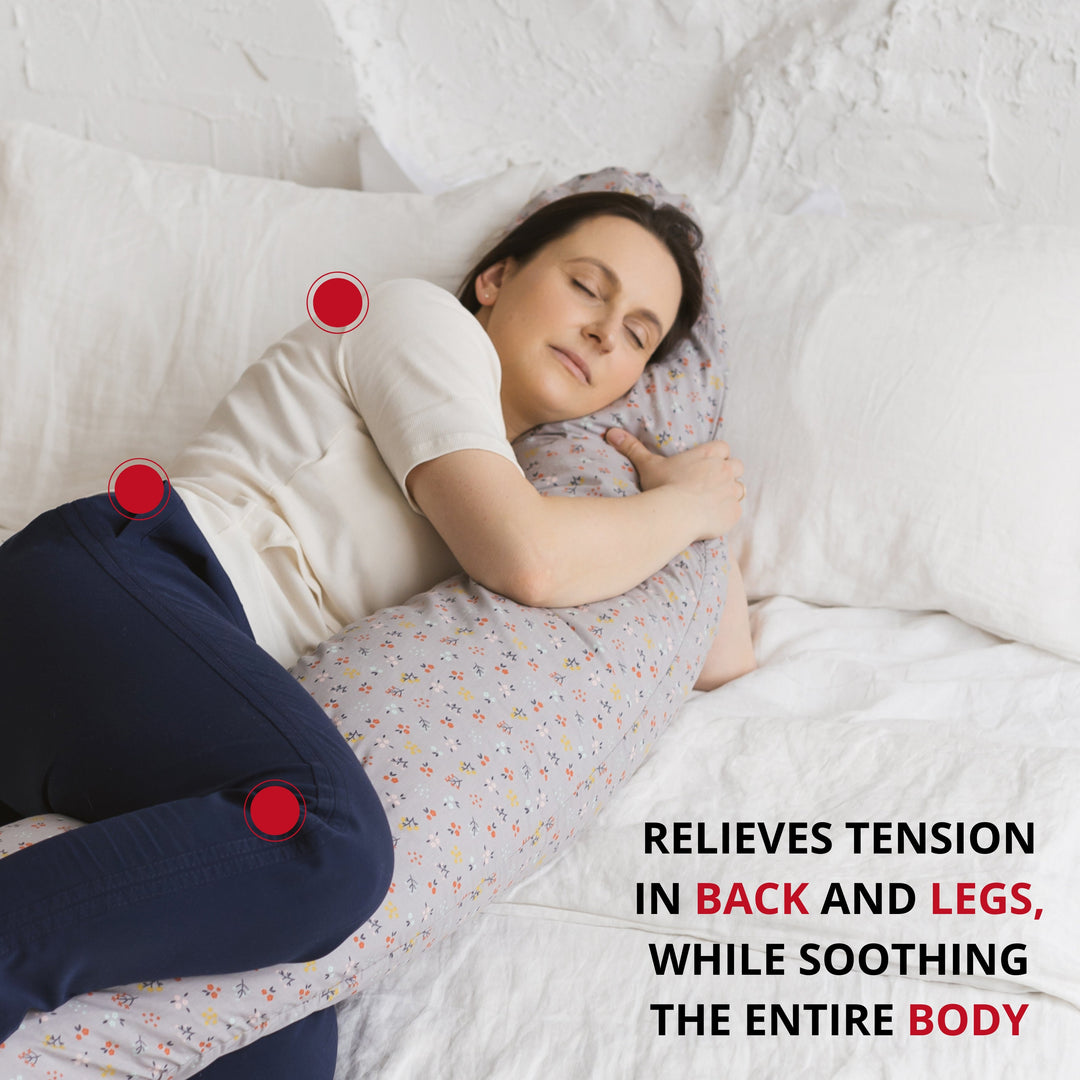 Woman side-sleeping supported by the MINICAMP Grey floral C-Shape Pillow