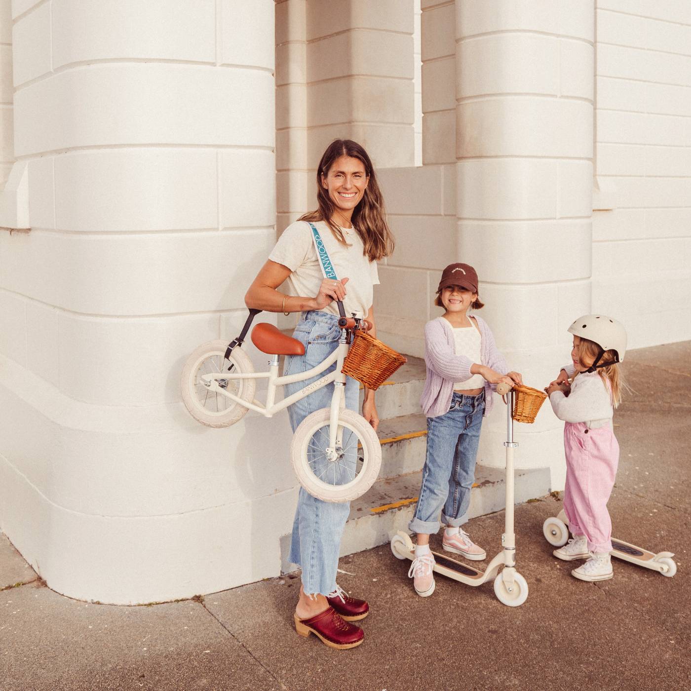 Family with bikes and scooters in outdoor lifestyle setting, Banwood