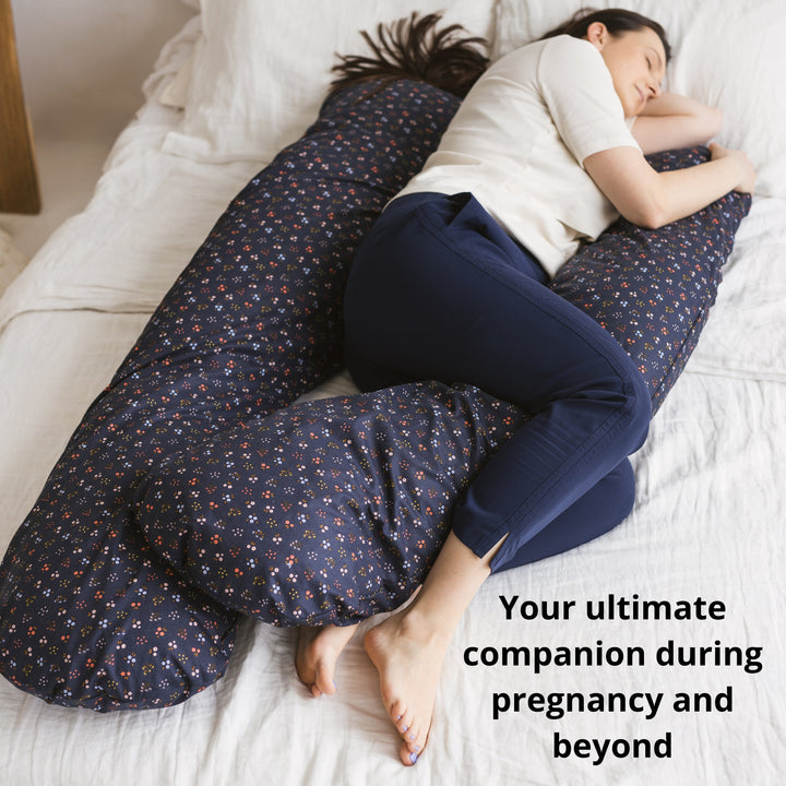 Woman sleeping using the MINICAMP U-shaped comfort pillow in navy blue