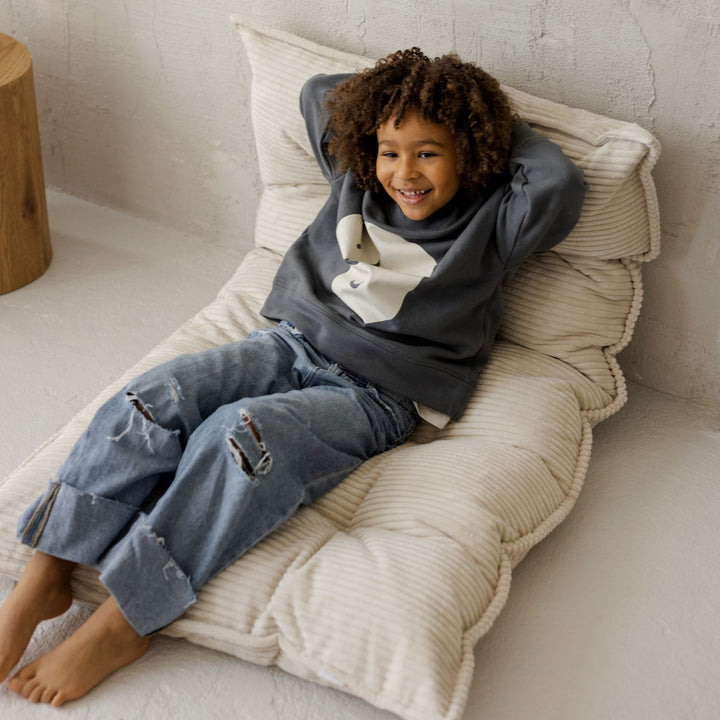 MINICAMP ecru tufted floor cushion shown from a different angle