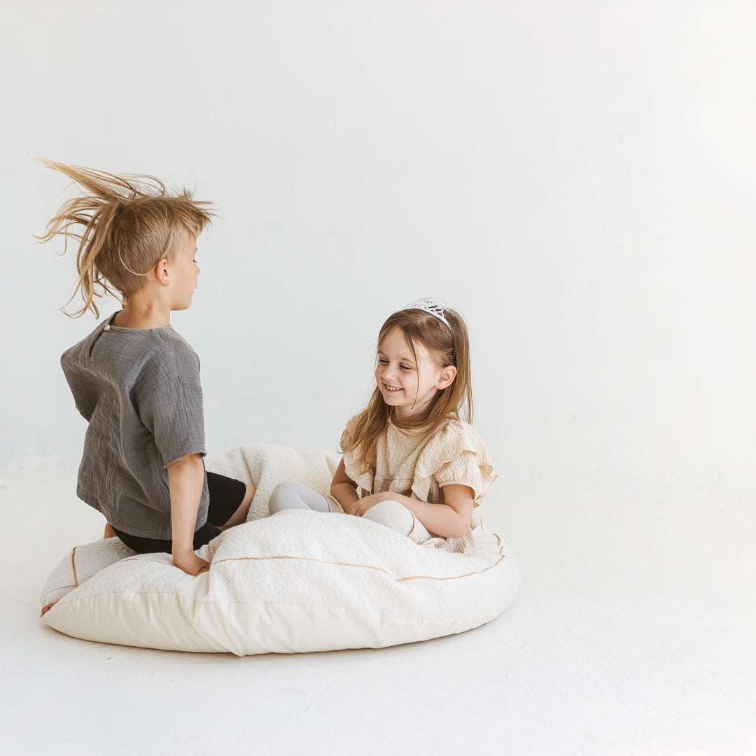 MINICAMP ecru boucle floor cushion, angled view