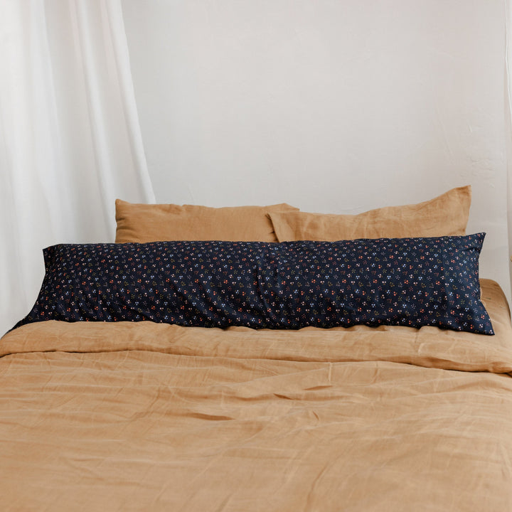 MINICAMP Long Maternity and Lumbar Support Pillow, navy blue floral organic cotton cover, detail photograph on a bed