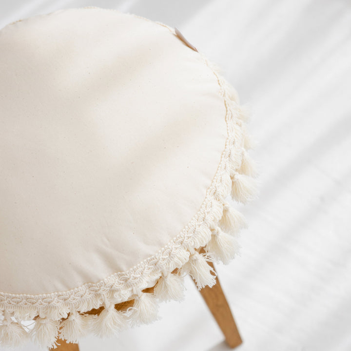 Close-up of the tassel trim on the MINICAMP Round Tassel Cushion