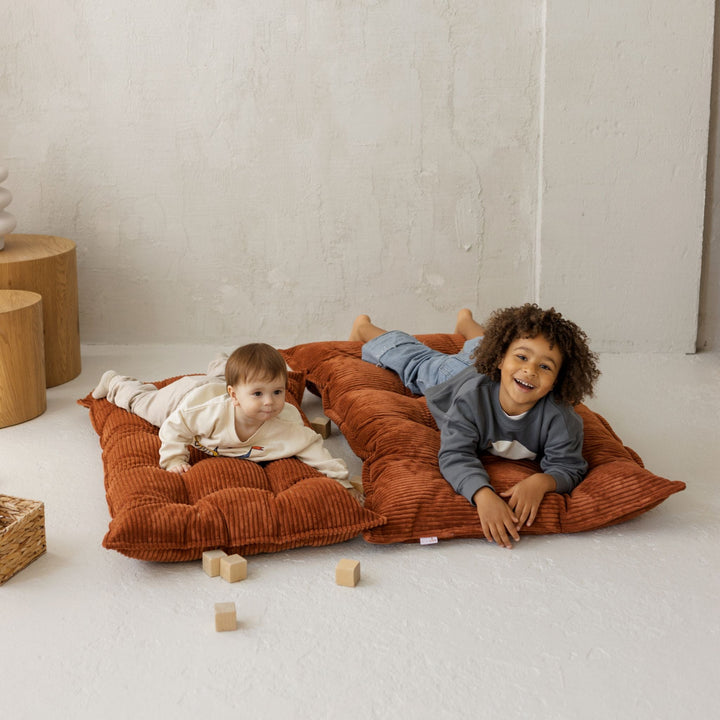 MINICAMP terracotta tufted floor cushion laid flat as a floor mattress