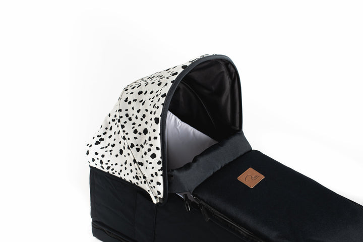 Roma Gemini 2 Carry Cot in Dalmatian, side view fitted to pushchair