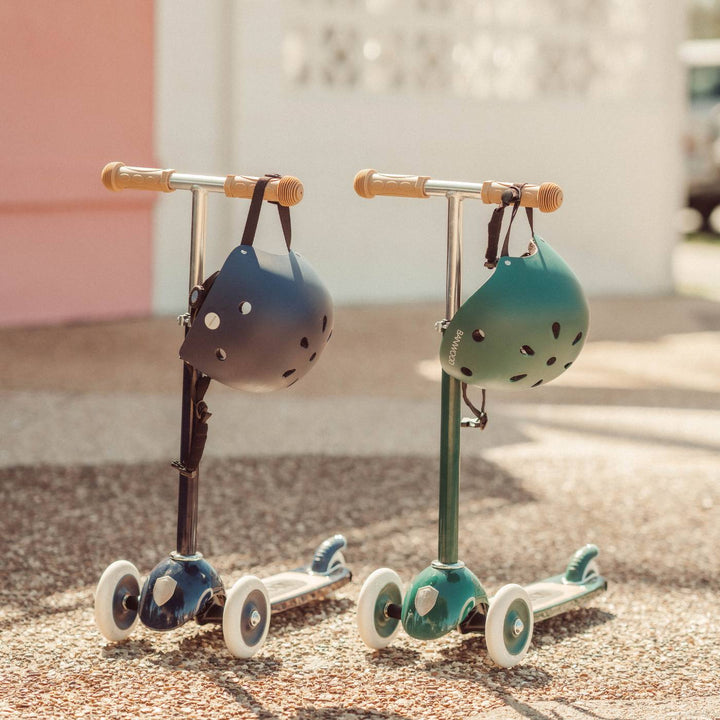 Two scooters displayed side-by-side with navy and teal baskets Banwood