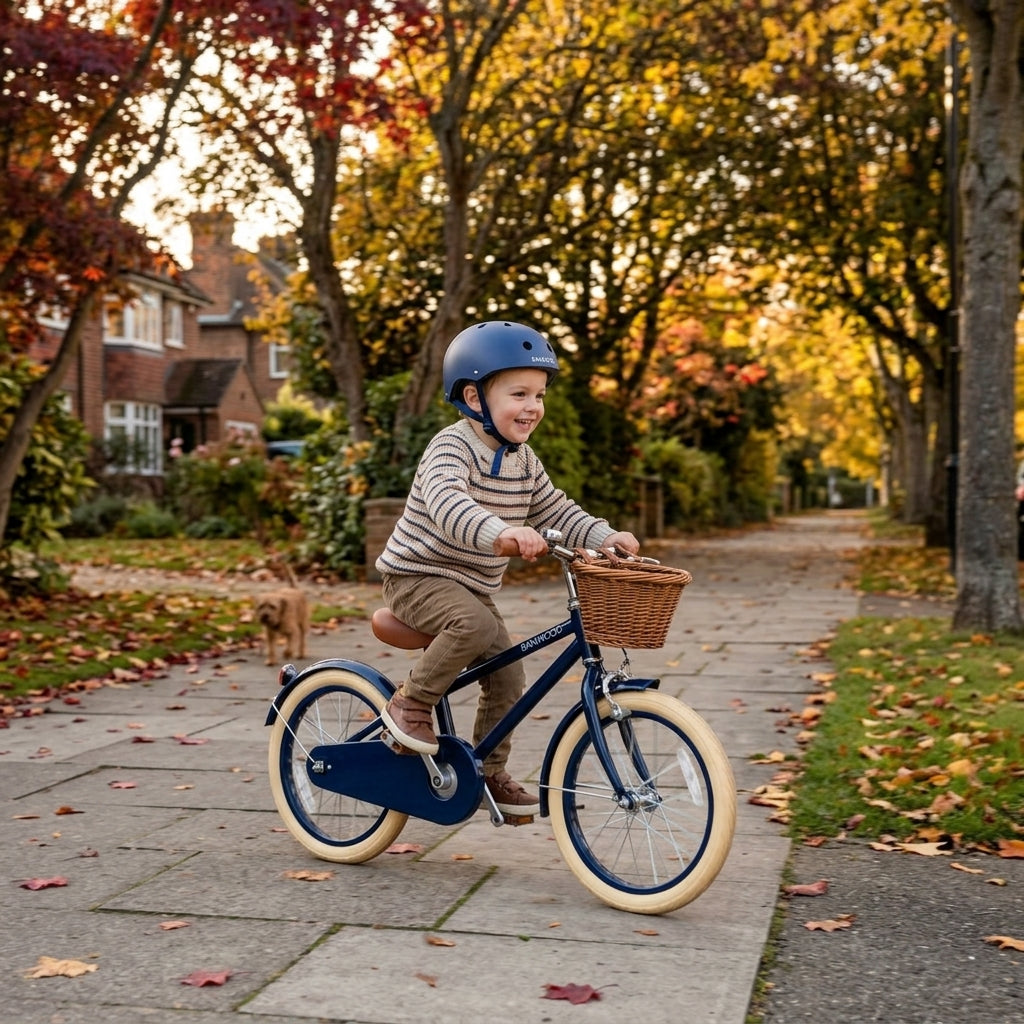 Child riding the navy Banwood Classic Bicycle along a suburban pavement
