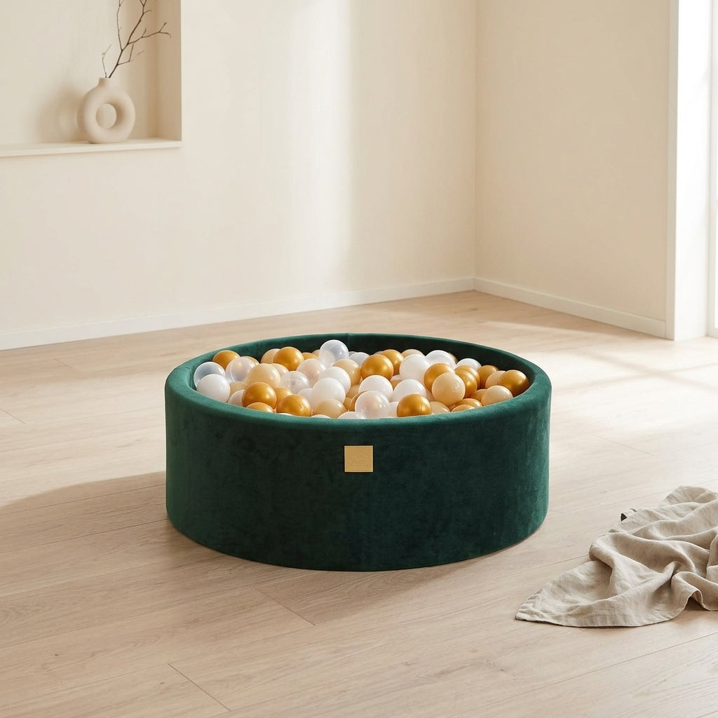 MeowBaby dark green round velvet ball pit placed as a centrepiece in an open playroom corner