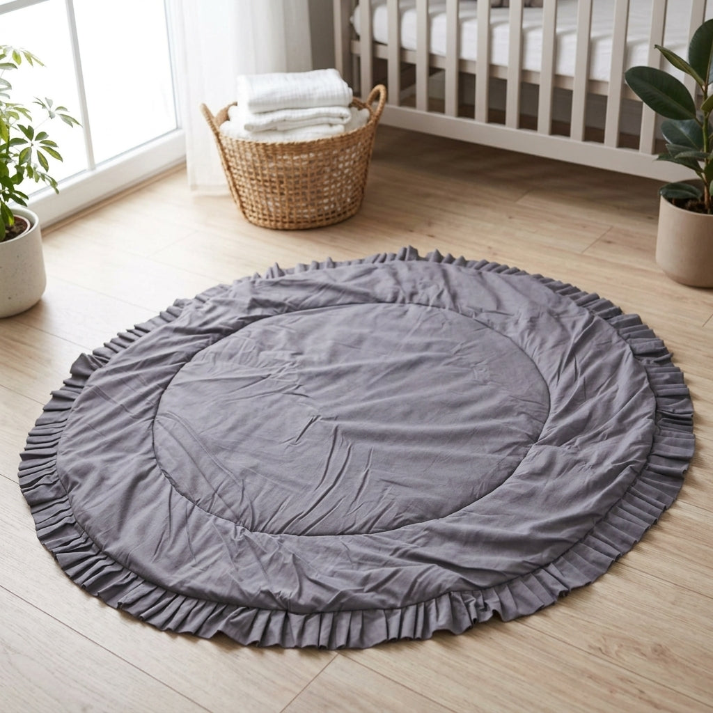 MINICAMP Kids Playmat with ruffled border in grey styled in a nursery setting