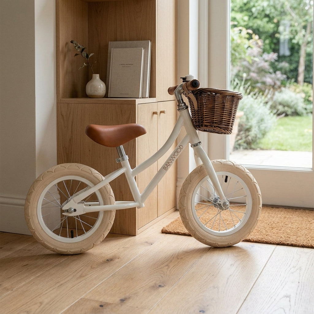 Banwood Balance Bike in White shown in a calm outdoor setting