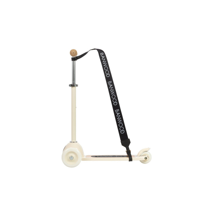 Cream scooter with black carry strap at angle showing beige grip attachment