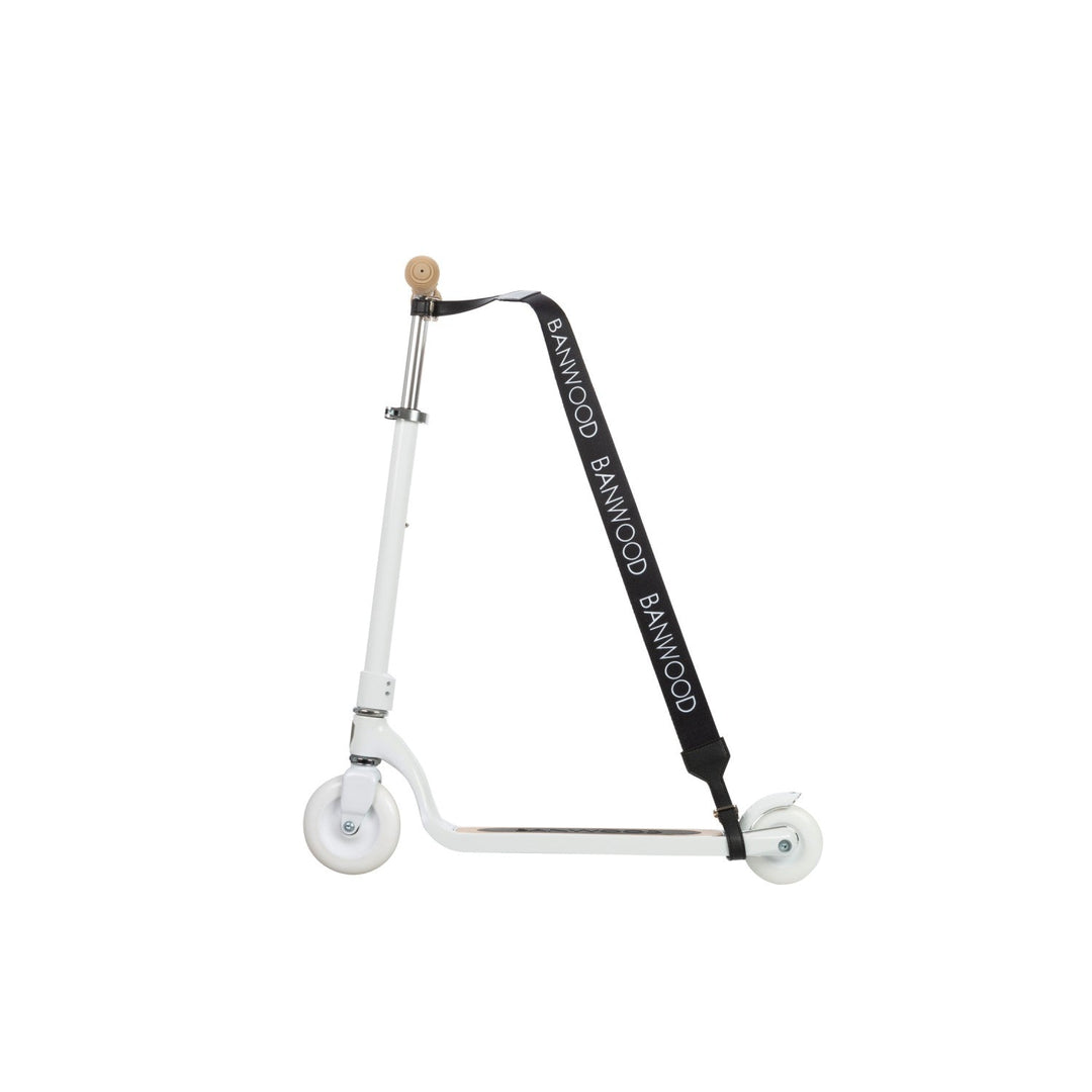 White scooter side profile with black carry strap attached to steering handle