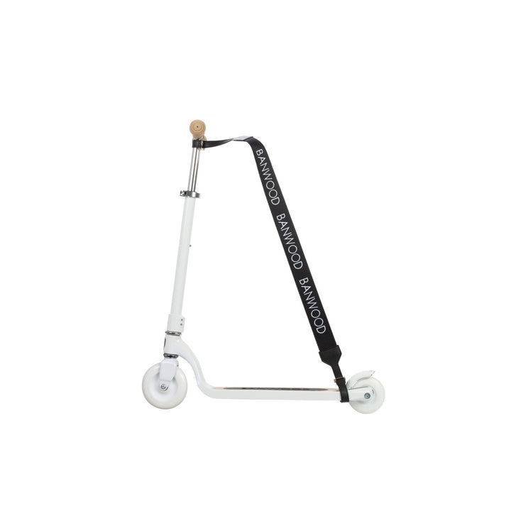 White scooter side profile with black carry strap attached to steering handle