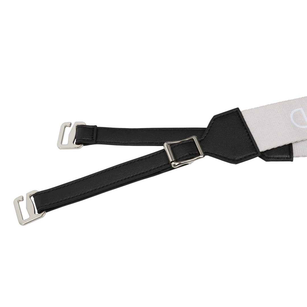 Close-up of black leather strap with metal buckle hardware and adjustment detail