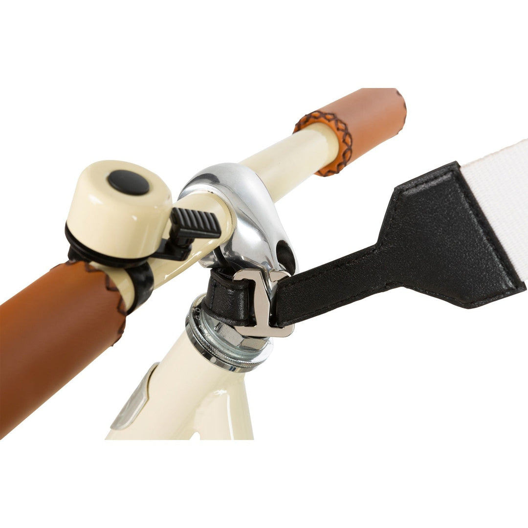 Handlebar junction detail showing hook attachment and carry strap connection on cream bike