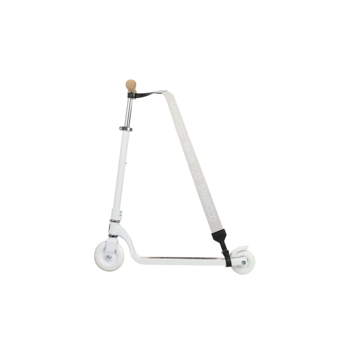 White scooter with cream carry strap hanging from stem against white background