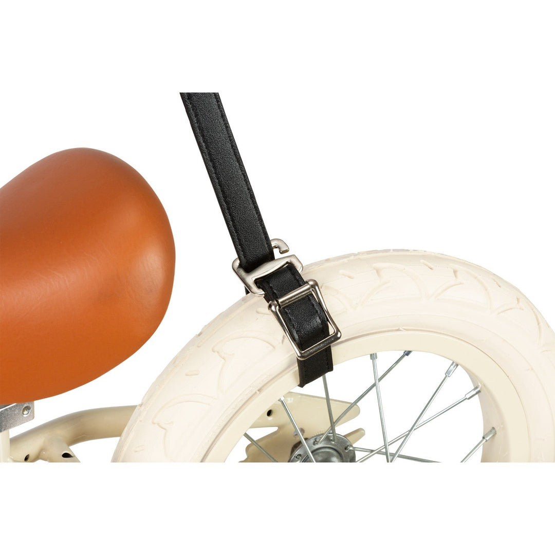 Teal strap attached to balance bike handlebar with metal buckle, Banwood