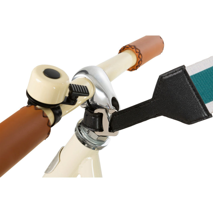 Cream scooter with extended teal carry strap laid flat, Banwood