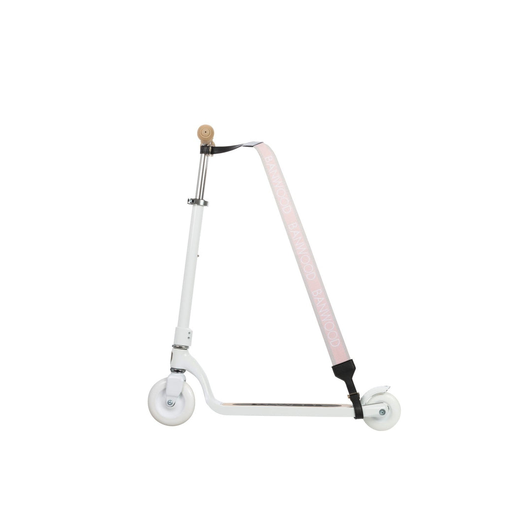 Scooter wheel with black shoulder pad and pink strap visible