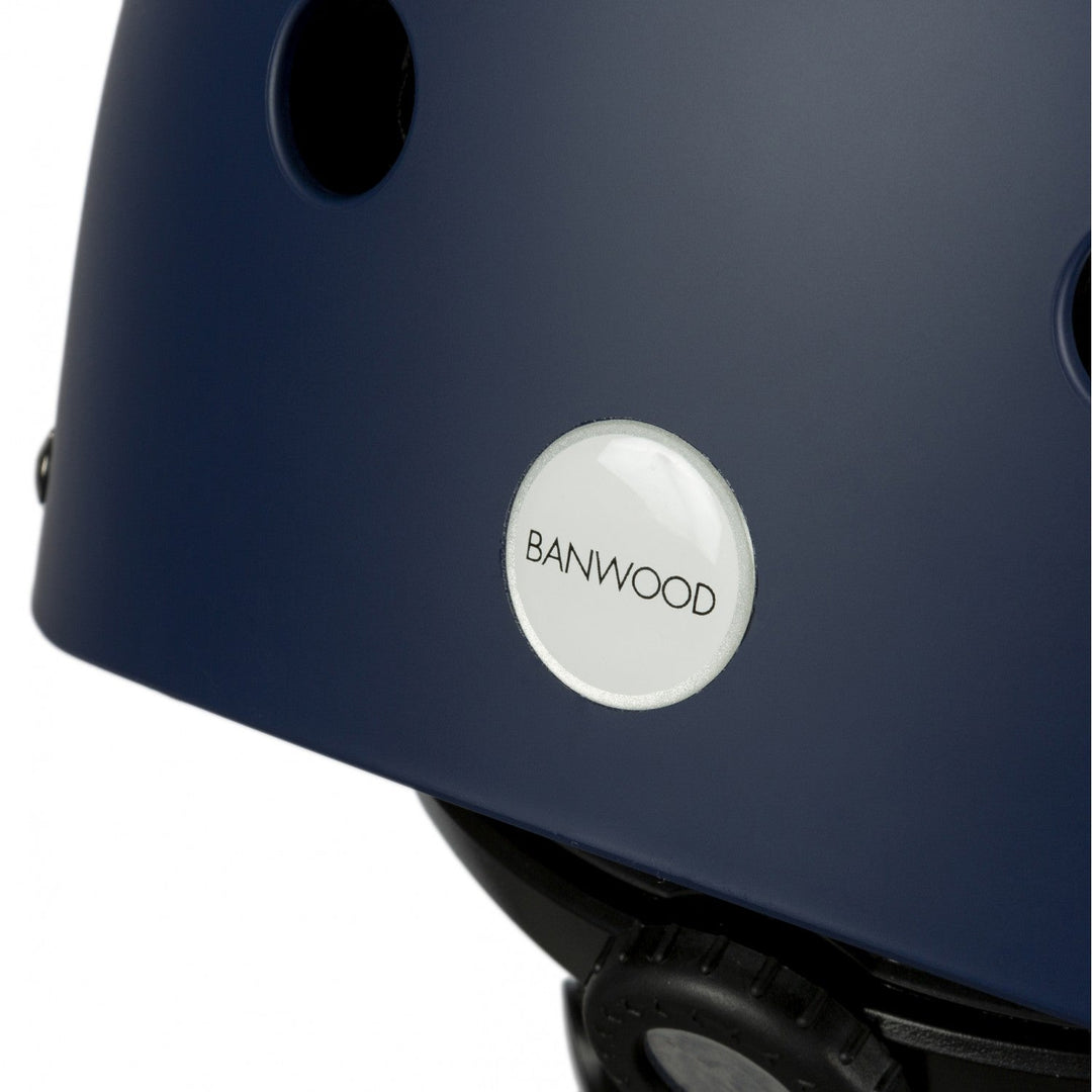Close-up of navy helmet side showing white Banwood branding badge