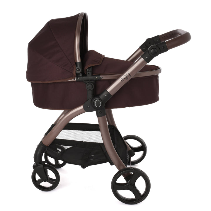 Roma Egg® Dolls Pram in Mulberry, side profile showing the chassis, mesh under-basket and wheels