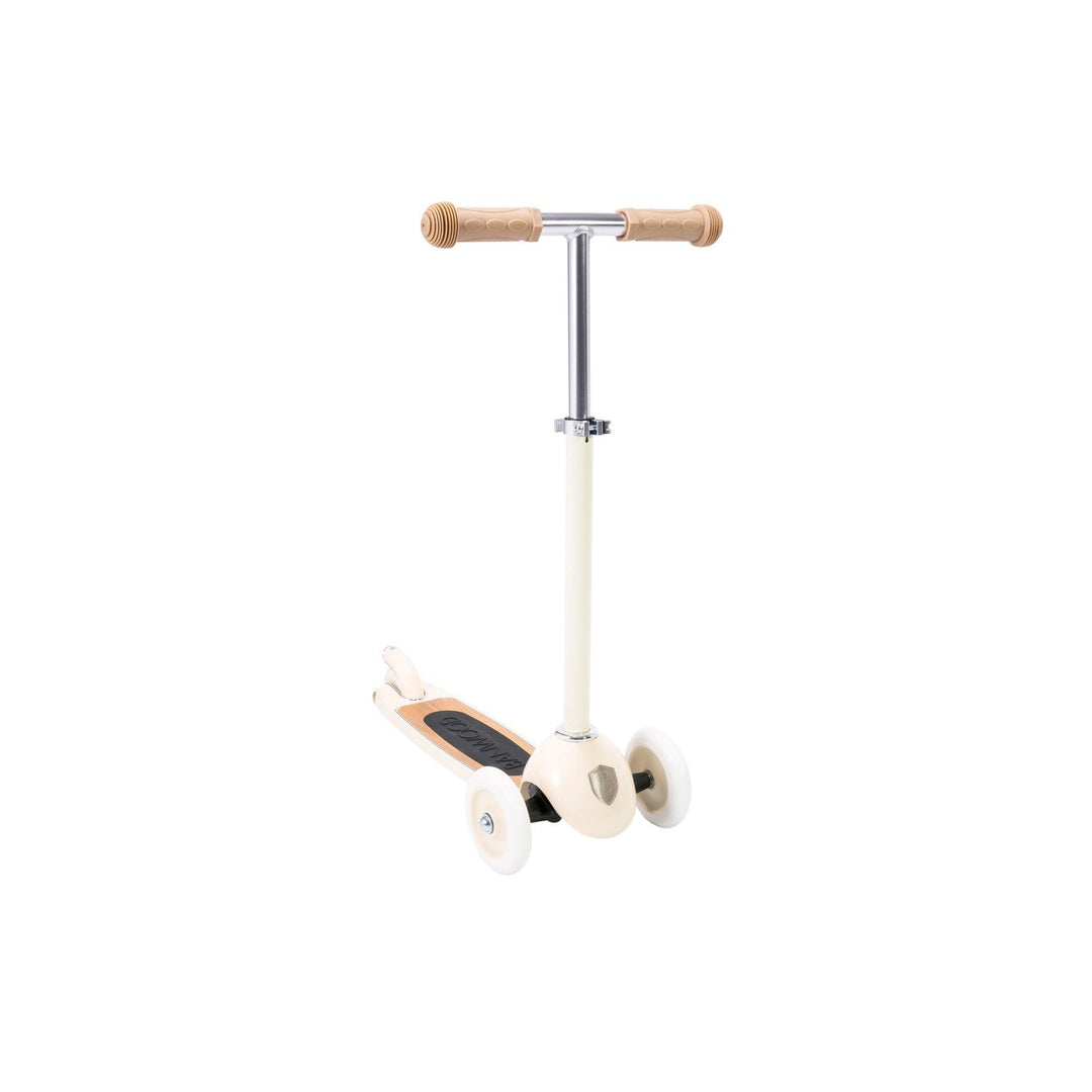 Left-side three-quarter view of cream scooter with wheels and wooden T-bar handlebar