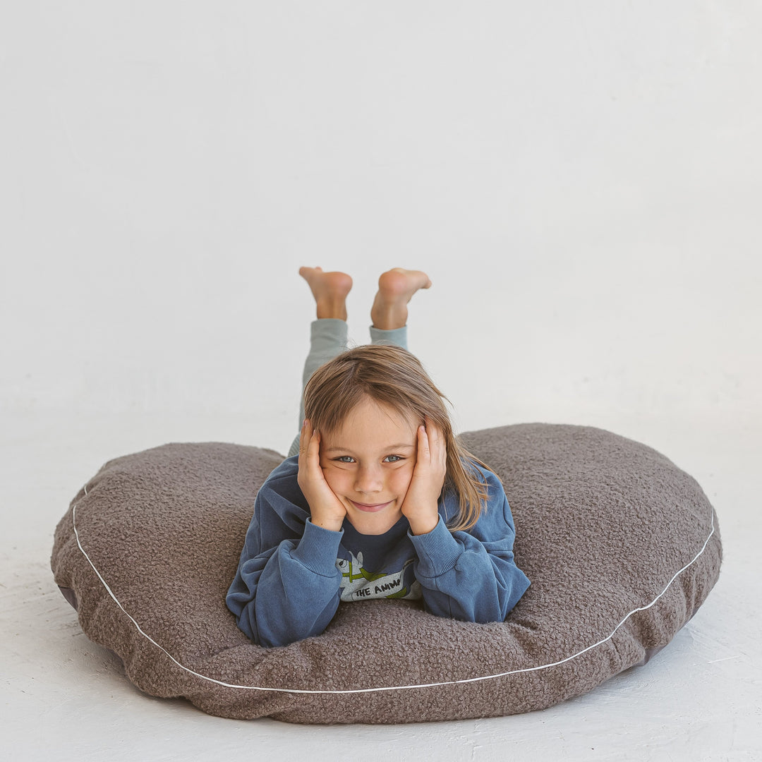 MINICAMP grey boucle floor cushion showing the removable cover